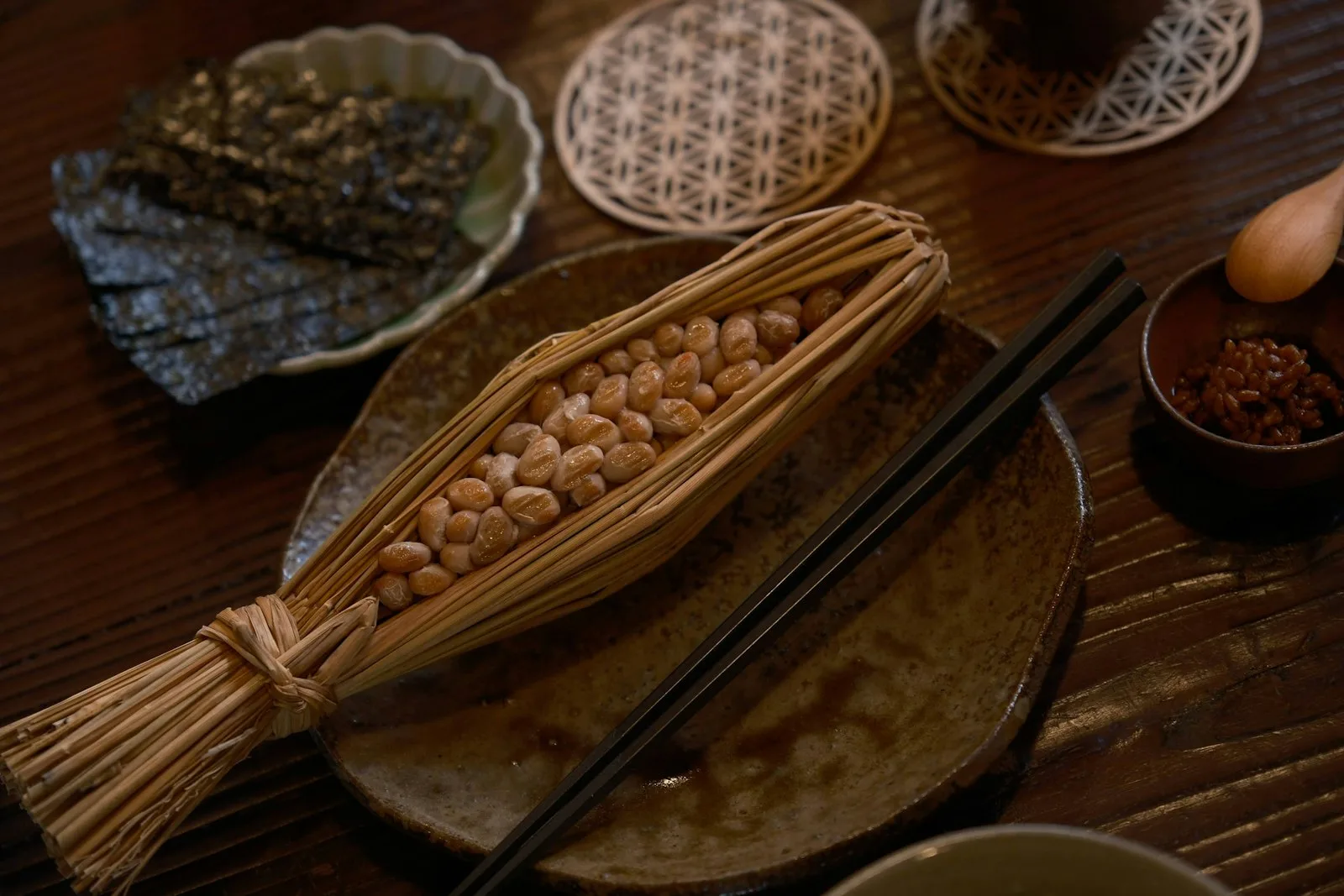 A wooden table set with several small izakaya-style share plates