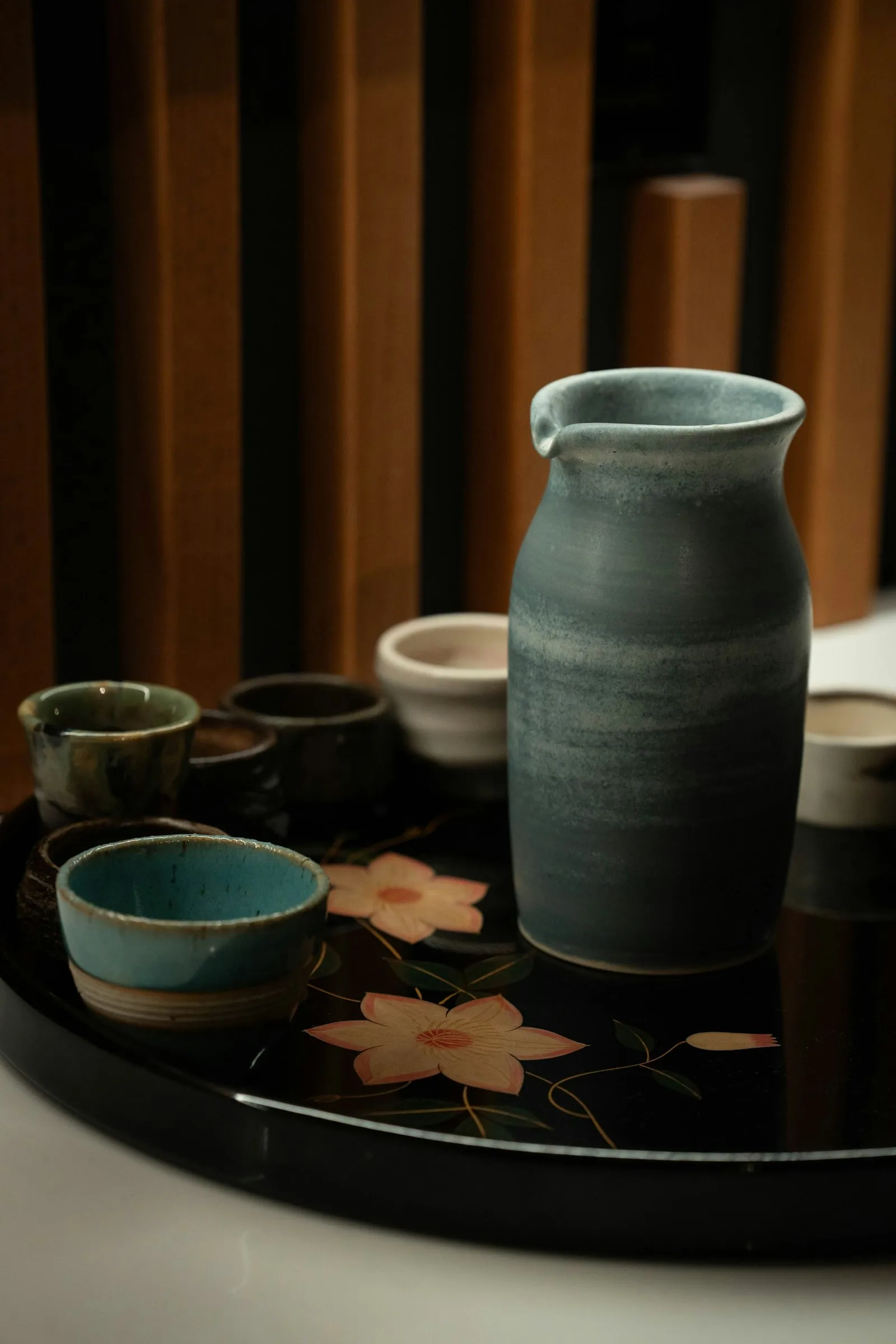 Ceramic sake cups and pitcher on a tray